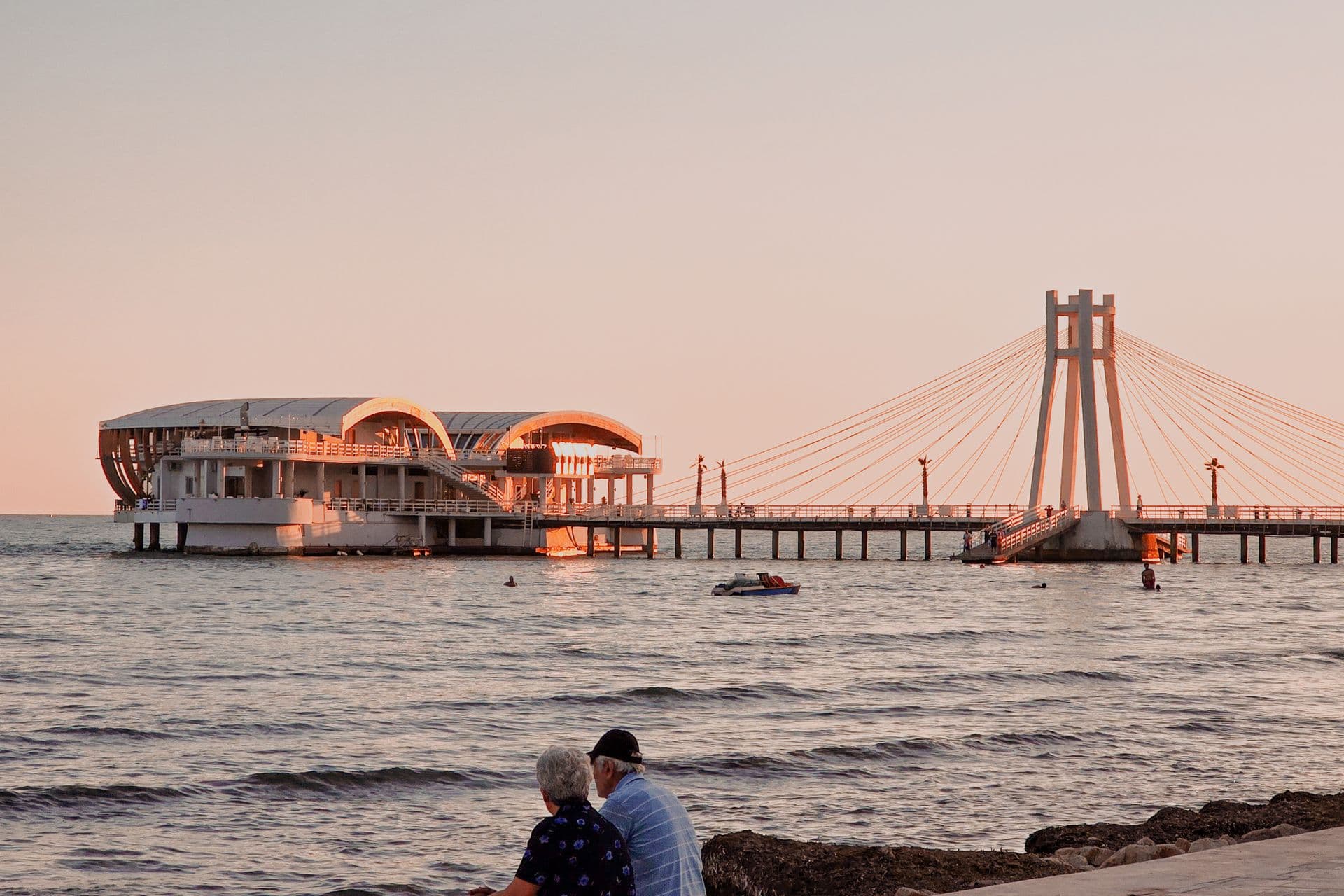 Durres beach pier and cable-stayed bridge at sunset