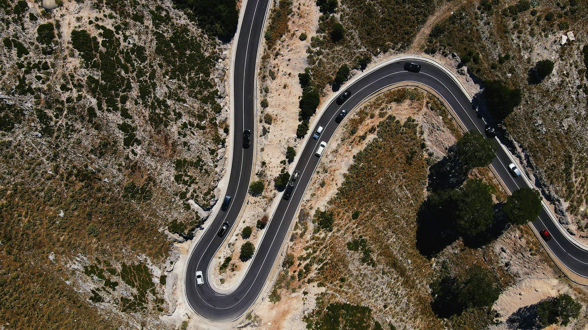 Cars on a winding mountain road in Albania