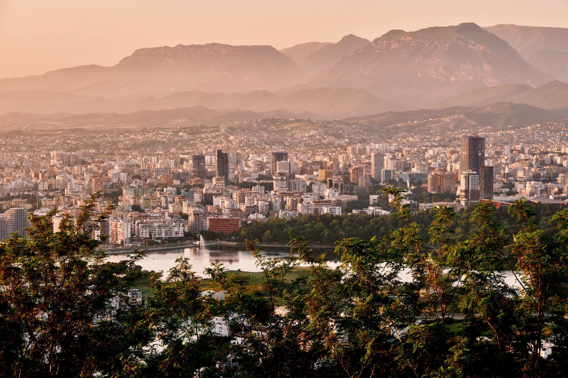 Aerial view of Tirana with the lake park and Dajti mountains